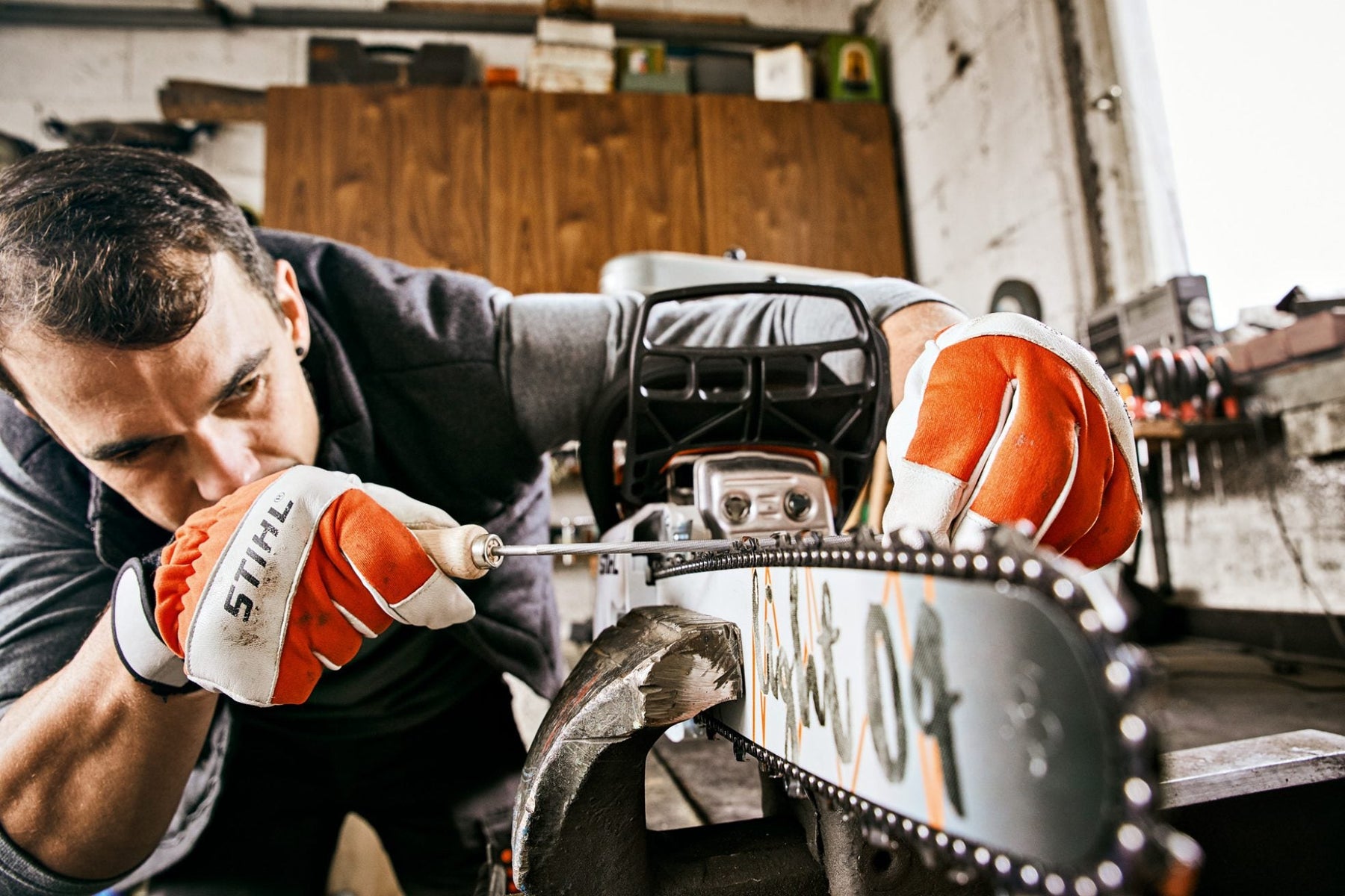 Man sharpening a chainsaw