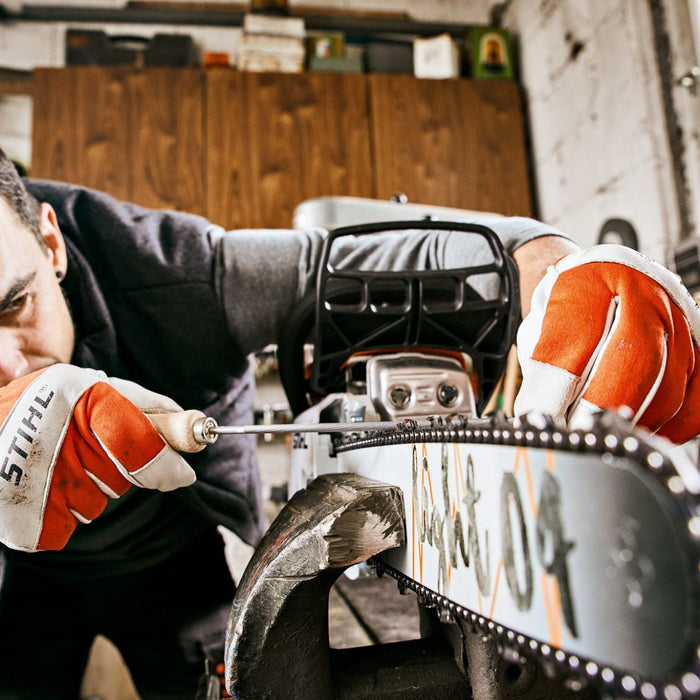 Man sharpening a chainsaw