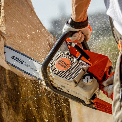 Stihl chainsaw in use cutting through a tree