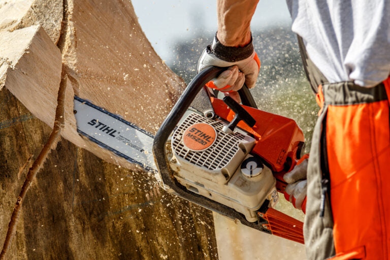 Stihl chainsaw in use cutting through a tree