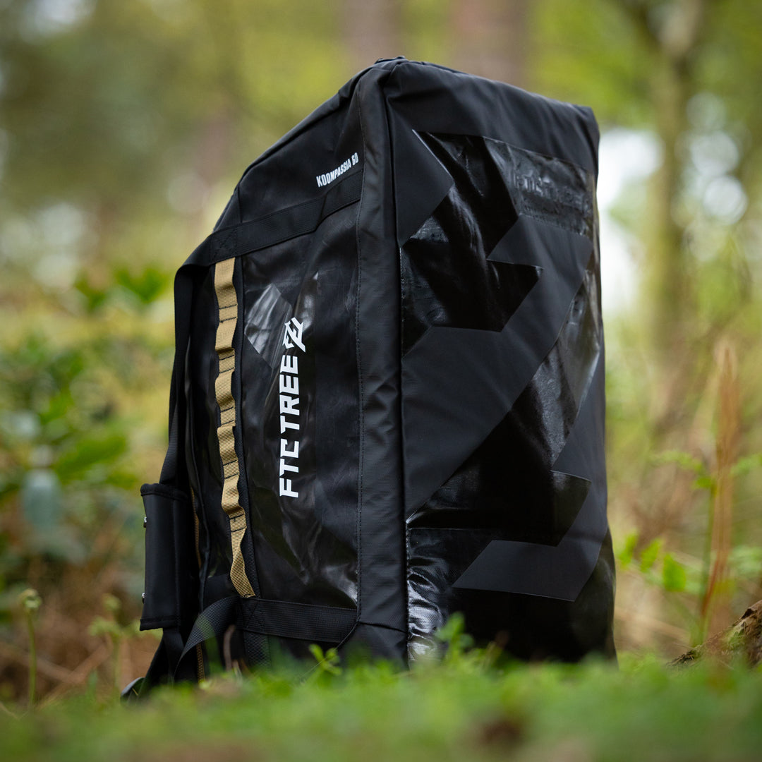 Black backpack with 'FTC Tree' branding in a forest setting